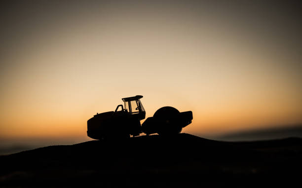 istock Abstract Industrial background with construction crane silhouette over amazing sunset sky. Mobile crane against the evening sky. Industrial skyline. Selective focus 1192595875