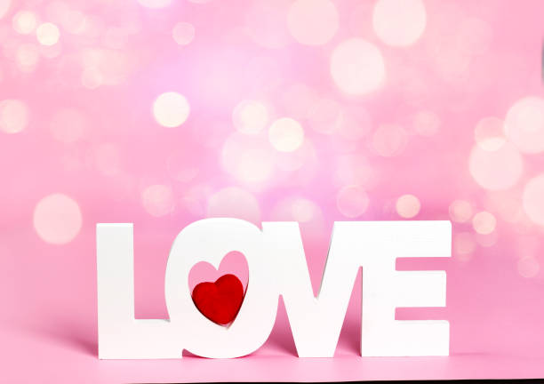 Word love at pink color background with bokeh