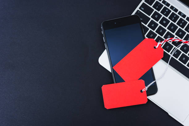 istock Online shopping Blank red 2 tag on smart phone and laptop computer 1192596872