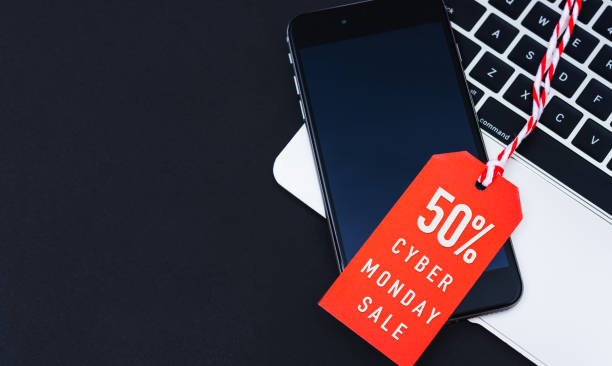 istock Cyber Monday Sale text on red tag have mobile smart phone over laptop computer 1192596907