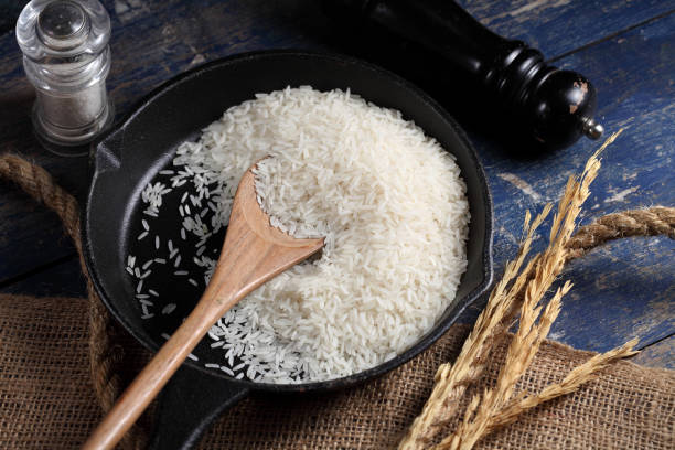 istock Close up white rice in measuring cup on table, Thai Jasmine rice in rustic kitchen background 1192601287