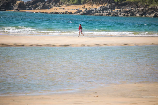 Tourist woman on beach and tropical sea at Phra Thong Island, Phang Nga Province, Thailand.