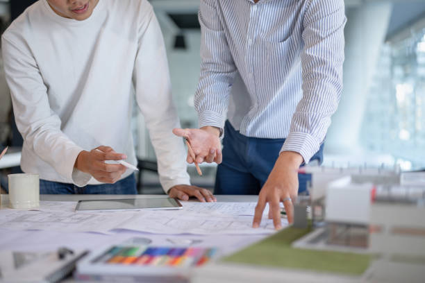 istock Brainstorming Architects teamwork discussing,designing and sketching the building construction project. 1192607920