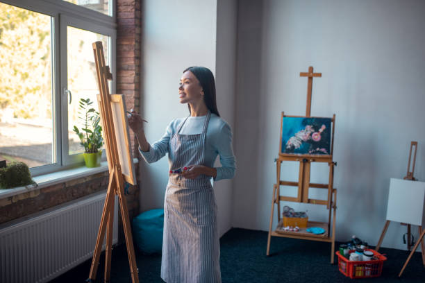 istock Nice good looking woman creating art in the studio 1192610654