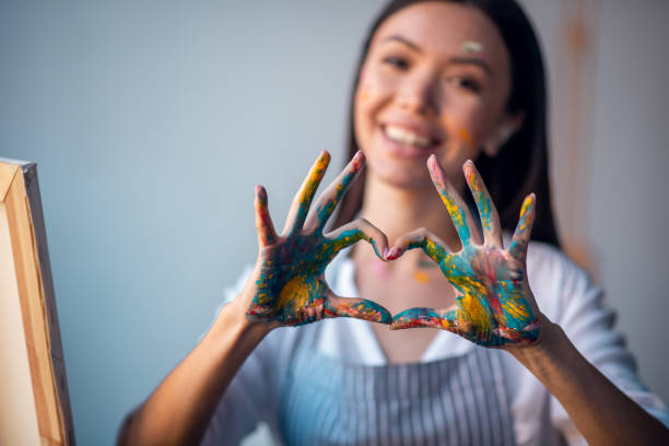 istock Selective focus of female hands in paint 1192610678