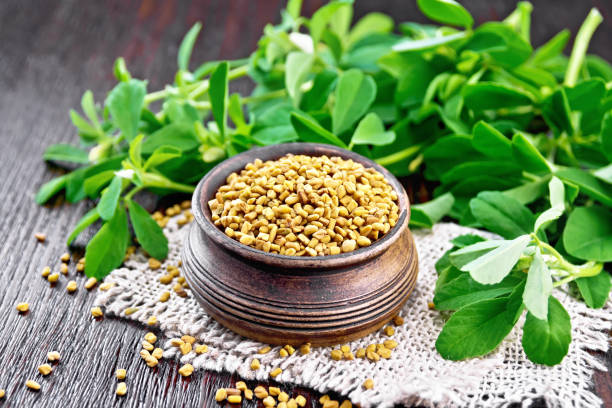 istock Fenugreek in bowl with leaves on board 1192610686