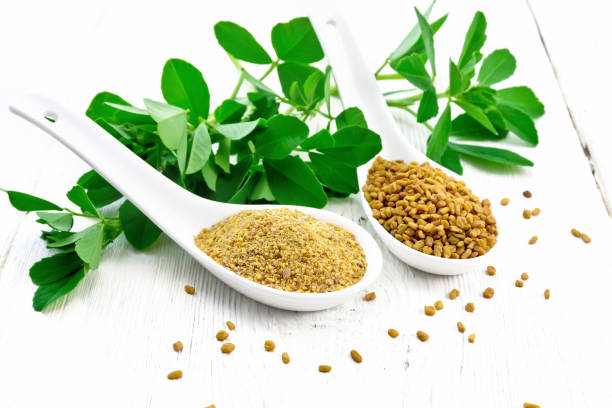 istock Fenugreek in two spoons with leaves on white board 1192610700