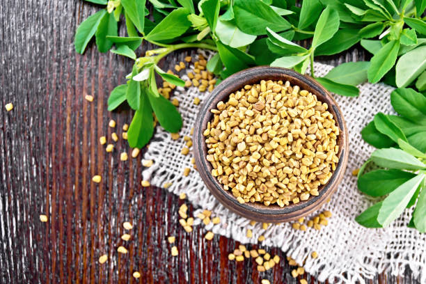 istock Fenugreek in bowl with leaves on board top 1192610704