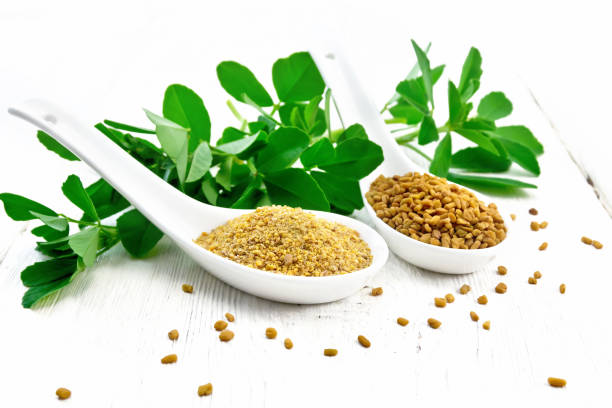 istock Fenugreek in two spoons with leaves on light board 1192610707