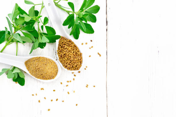 istock Fenugreek in two spoons with leaves on board top 1192610713