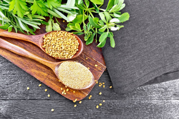 Fenugreek in two spoons with herbs on board top