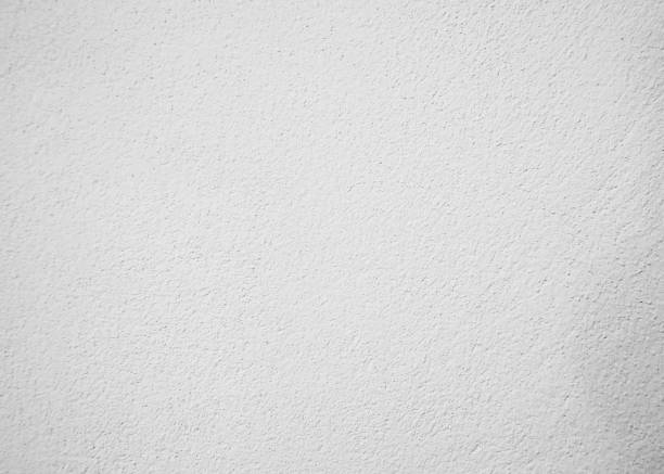 istock White pastel rough crack cement texture stone concrete,rock plastered stucco wall; painted flat fade background gray solid floor grain. 1192610912