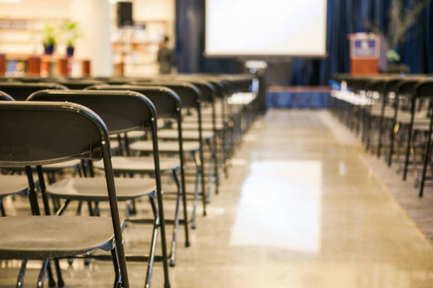 istock Chairs lined up in a row for presentation event 1192615208