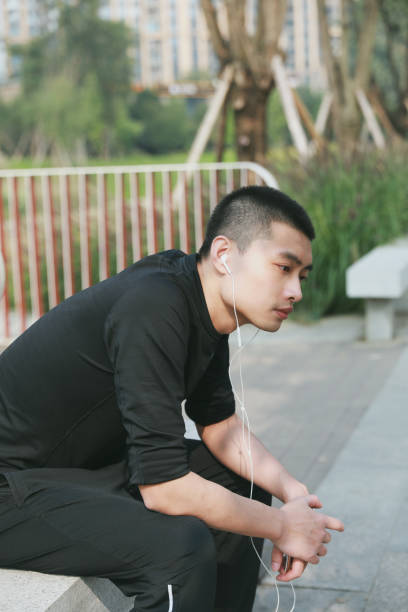 istock A young Chinese man resting on a bench after jogging in a public park 1192615343