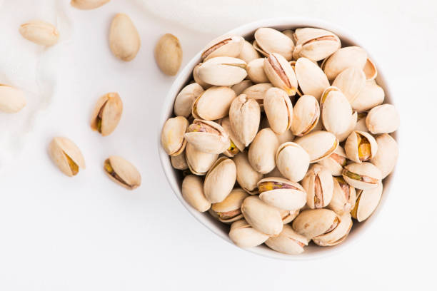 istock Bowl of roasted pistachios on a white background 1192615612