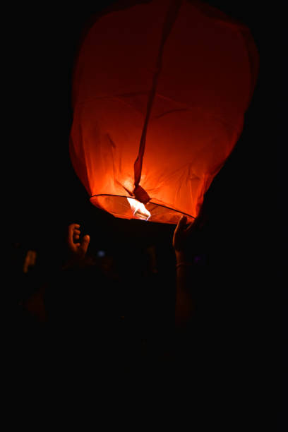 istock The man with his hand trying to fly sky lantern 1192621810