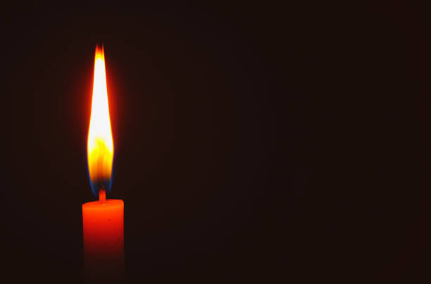 Candle light in a dark room., One candle flame at night