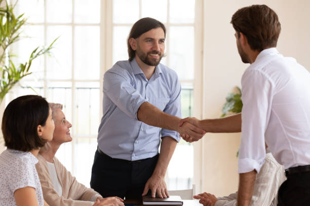 istock Smiling male boss shaking hands with young manager. 1192624622