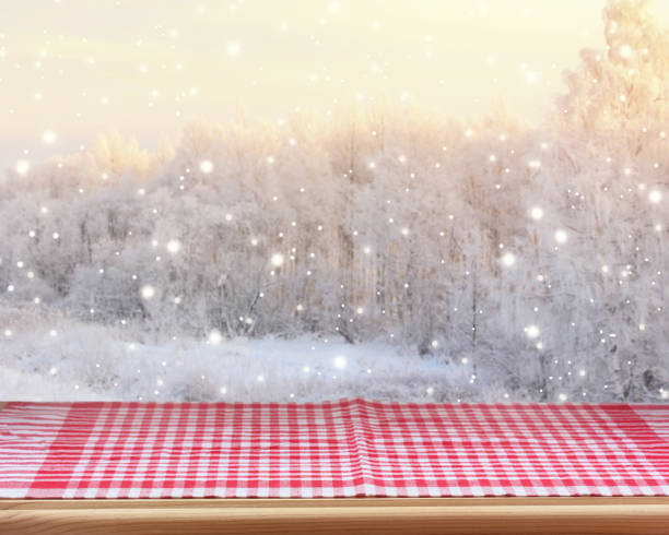 istock kitchen countertop with red checkered tablecloth on winter blurred background. 1192624946