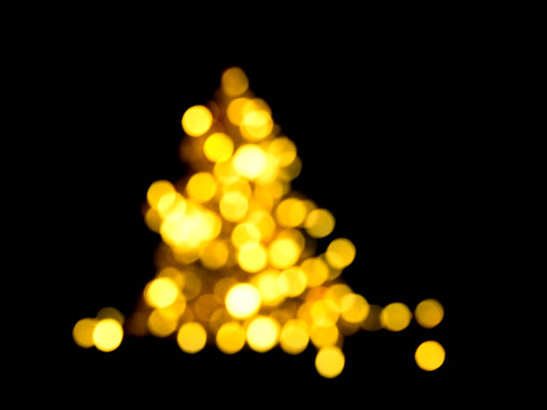 istock Holiday bokeh golden lights Defocused shiny evergreen tree shape 1192629595