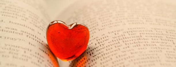 istock Red transparent glass heart lay in a book 1192630226