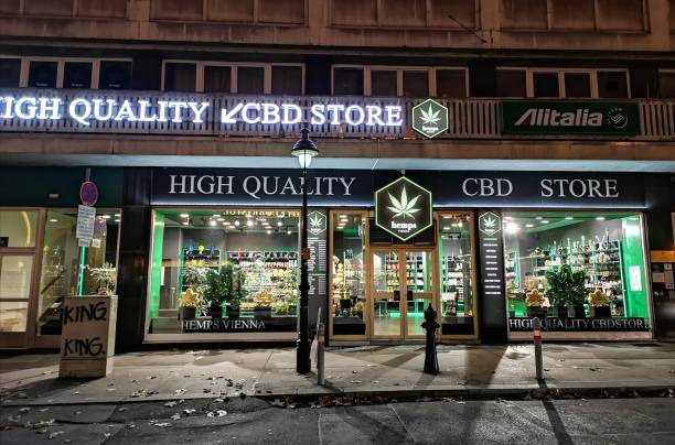 High Quality CBD Store - Vienna Vienna, Austria: December 01, 2019: High Quality CBD Store window at night with logo. Sellinghemp and CBD products for medicinal use. cannabis store photos stock pictures, royalty-free photos & images