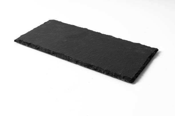 istock Black stone plate isolated on white background 1192634989
