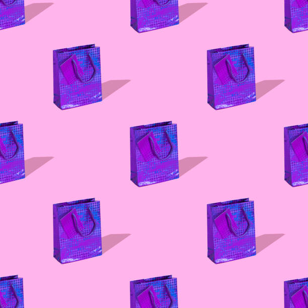 Seamless pattern made with various presents or gift bags on bright light pink background with strong shadows. Birthday concept