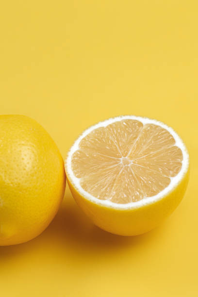 istock Lemon fruit slice and whole lemons on yellow background. 1192635041