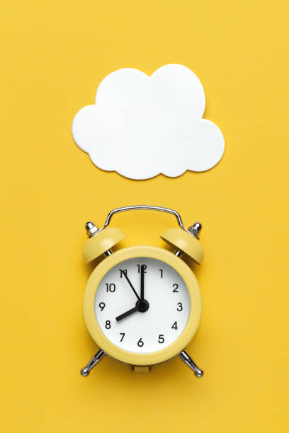 istock Yellow round alarm clock and white cloud on the yellow background. 1192635119