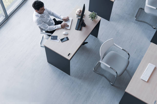 istock Top view of executive, manager, or engineer drinking coconut juice working on computer sitting in creative office prepare travel document for summer trip 1192636177