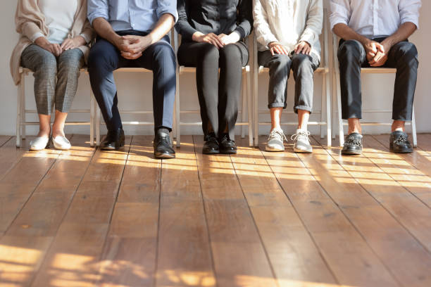 istock Close up cropped image of diverse people sitting in row. 1192636252