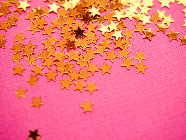 istock Golden stars glitter on pink background 1192636926
