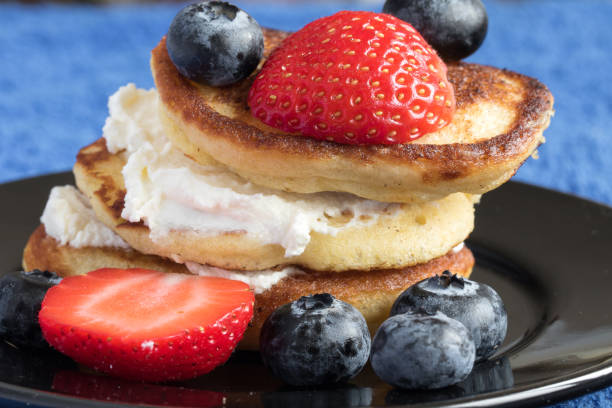 istock Breakfast fritters with cream and fresh berries 1192639015