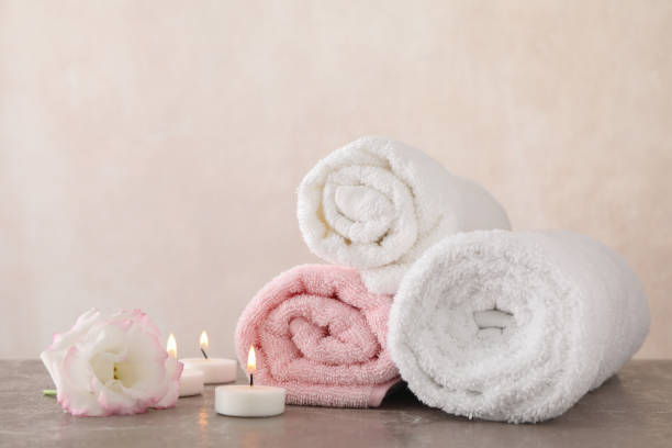 istock Towels, candles and flower on grey background, space for text 1192640119