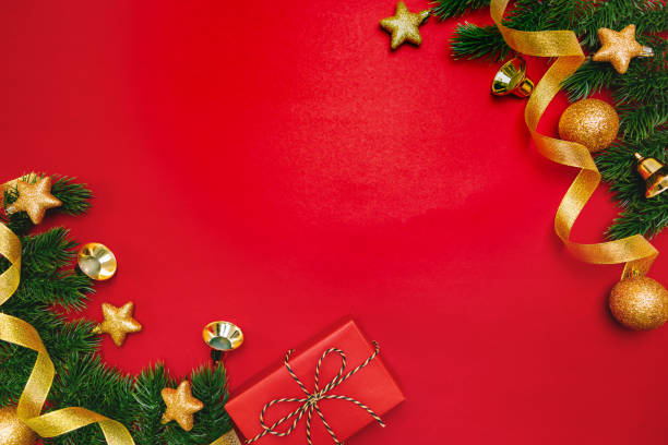 istock Christmas present and pine tree with xmas decoration on Red background 1192641170
