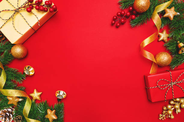 istock Christmas present and pine tree with xmas decoration on Red background 1192641213