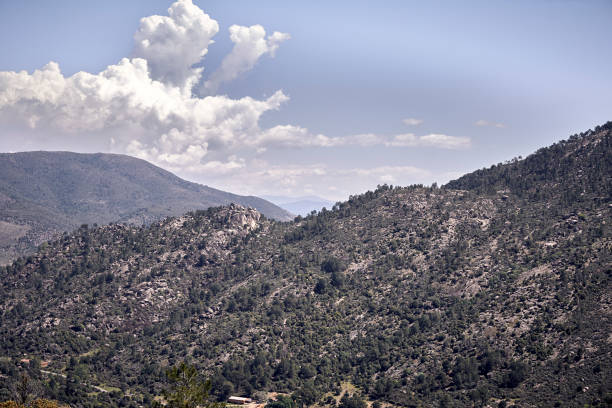 istock Panoramic of some mountains under a cloudy blue sky 1192641954