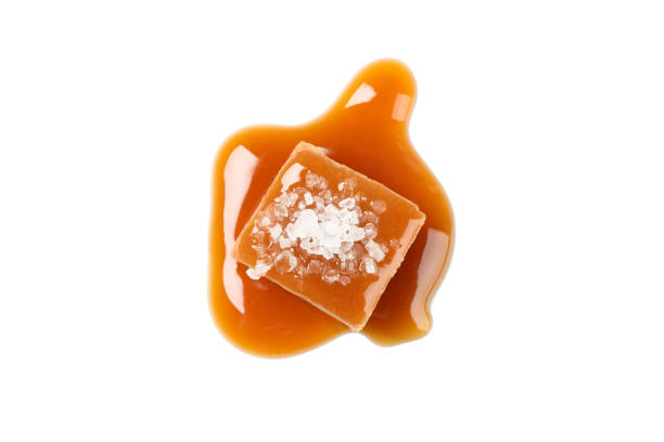 istock Salted caramel candy with sauce isolated on white background 1192642051