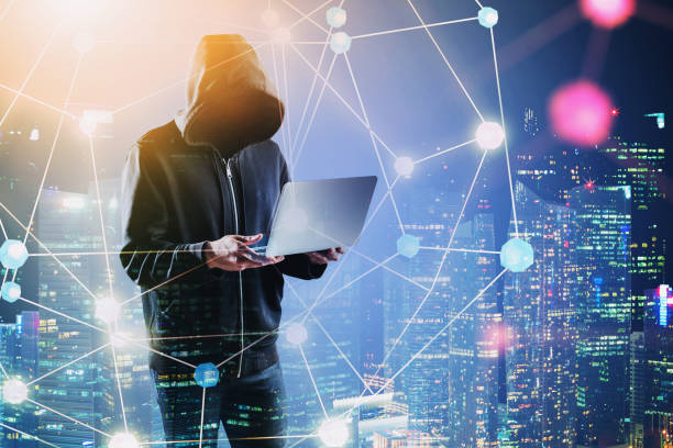 istock Hacker with laptop in night city, network 1192642124