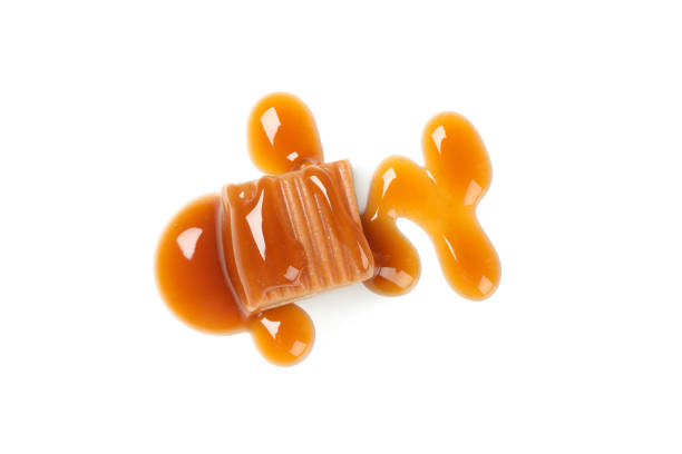 istock Caramel candy with sauce isolated on white background 1192642207