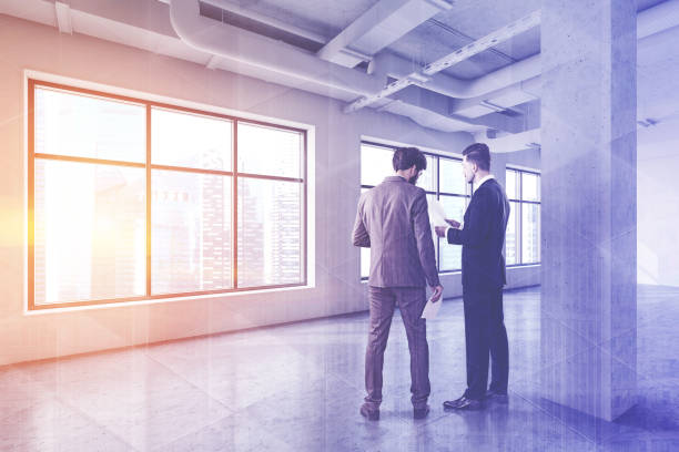 istock Businessmen in empty industrial style office 1192642212