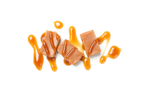 istock Caramel candies with sauce isolated on white background 1192643004