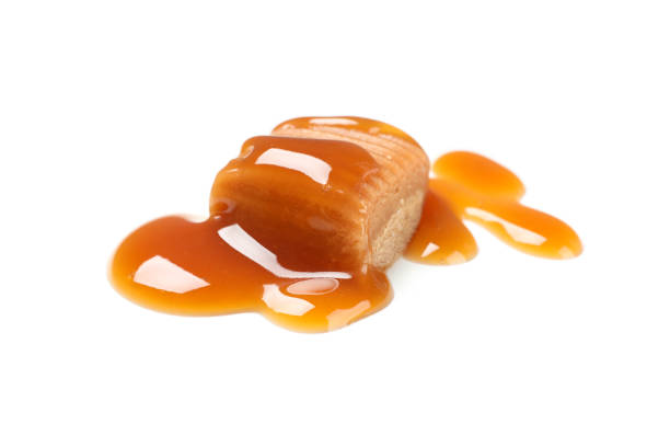 istock Caramel candy with sauce isolated on white background 1192643060