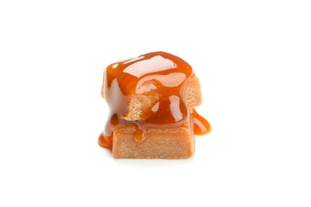 Sugar candies on a white napkin. Chocolate hard suckers close-up. Macro. Selective focus. Delicious creamy caramel