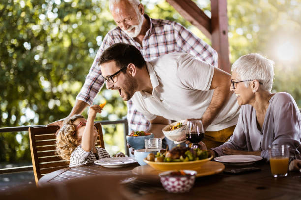 istock Happy extended family having fun during lunch time on a terrace. 1192643124