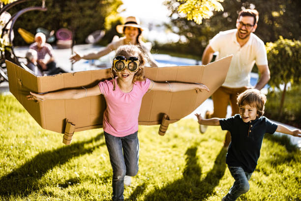 istock Playful kids having fun with their parents in the backyard. 1192643402