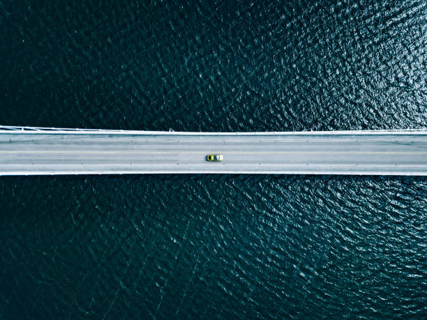 Aerial view of bridge road with cars over lake or sea in Finland Aerial top view of bridge road with cars over lake or sea in Finland sea bridge stock pictures, royalty-free photos & images