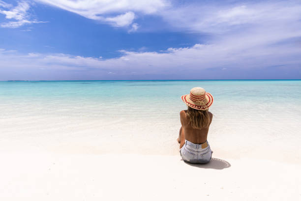 istock back view of relaxed woman looking at view from the beach. 1192647708