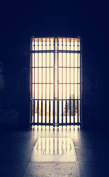 istock Door with Metal Bars in Dark Ambient 1192647932